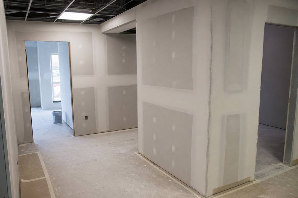 Commercial drywall finishing with corner bead and floor protection for Orlando drywall projects