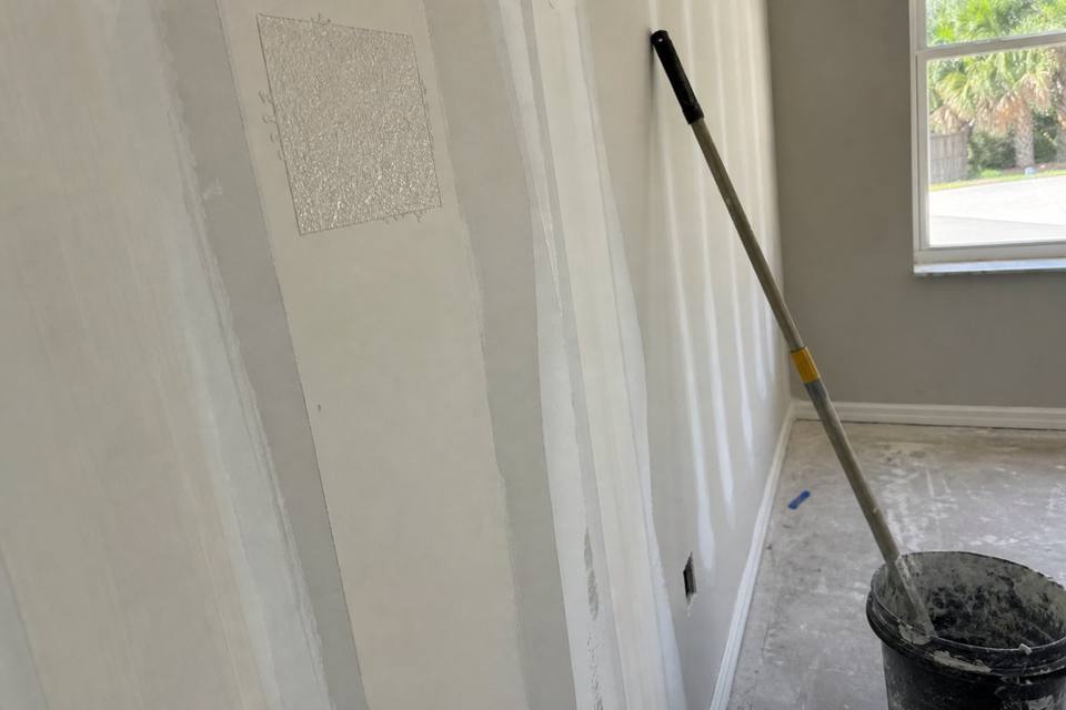 Taped seams and joint compound during drywall finishing for Orlando drywall projects
